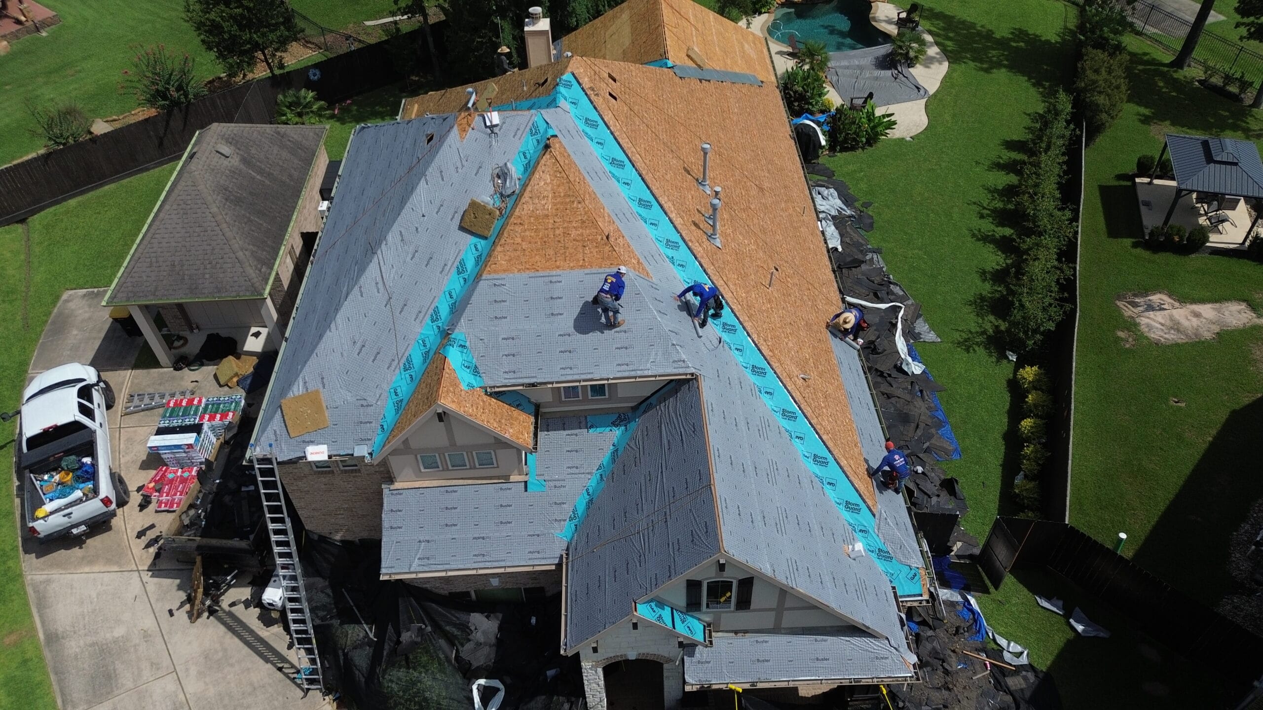 Aerial view of a Urena Roofing crew installing a new roof in Houston, TX